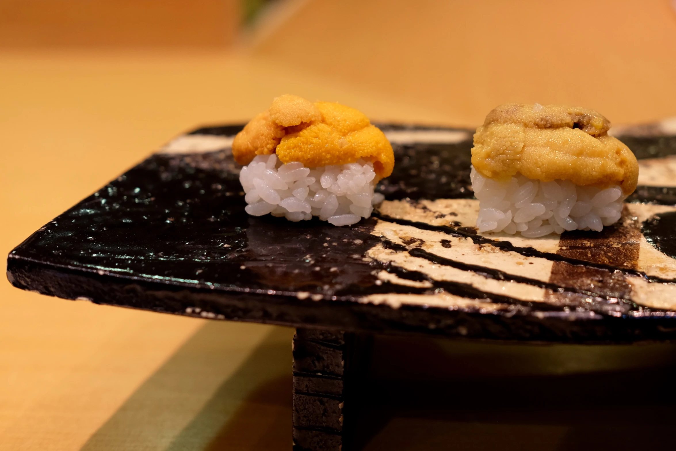 two pieces of sushi are sitting on a table