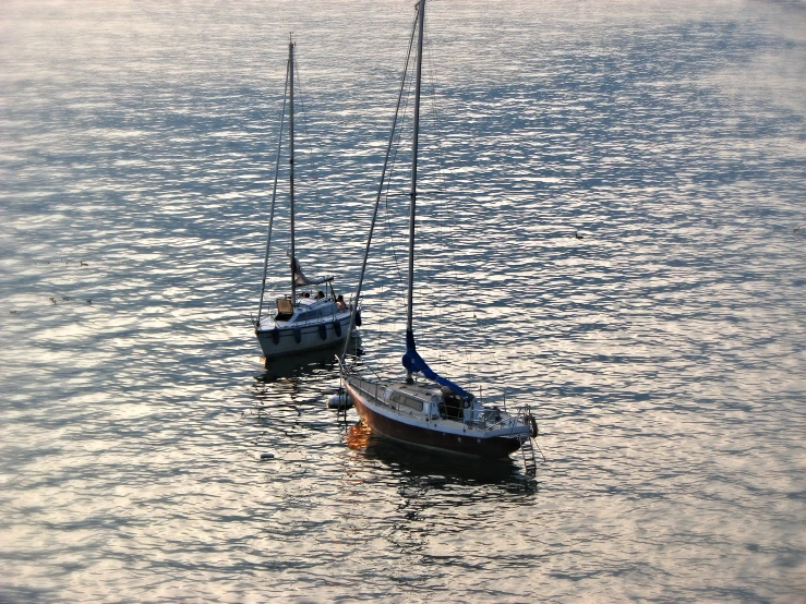 two boats in the water are floating on water