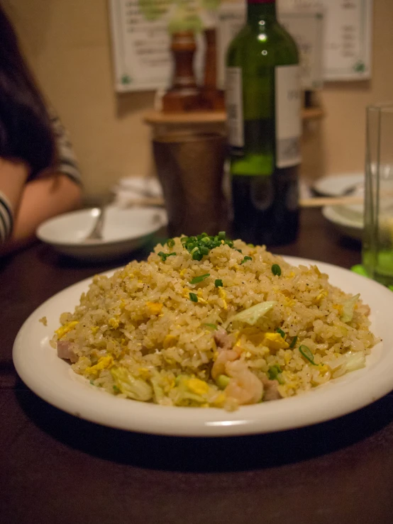 a person's leg sitting on a table next to food