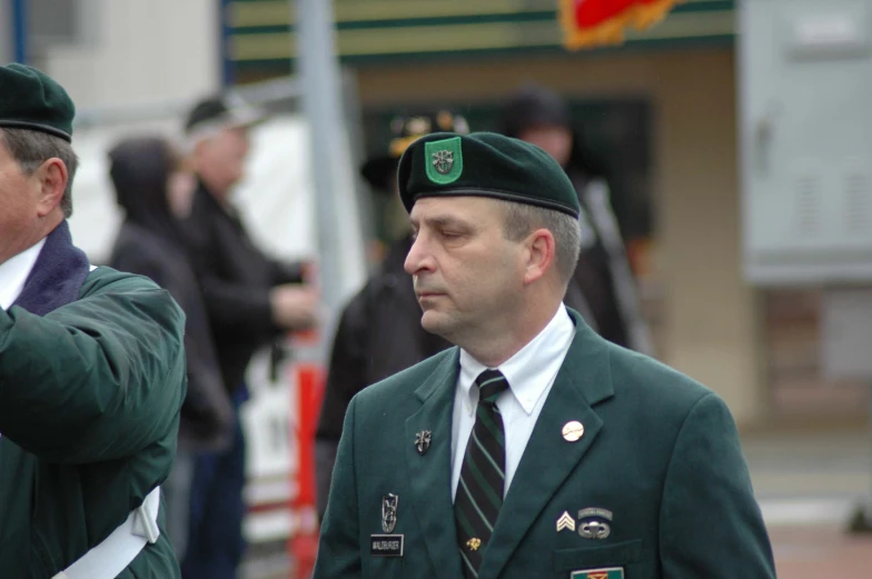 two men in military uniforms are standing together