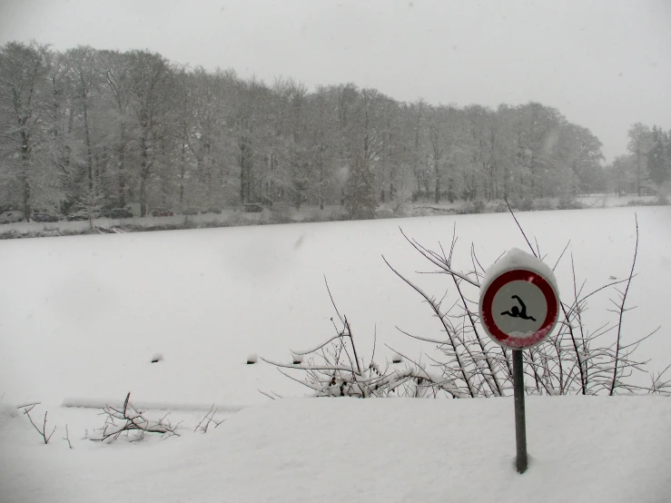 a sign on the side of a road on snow