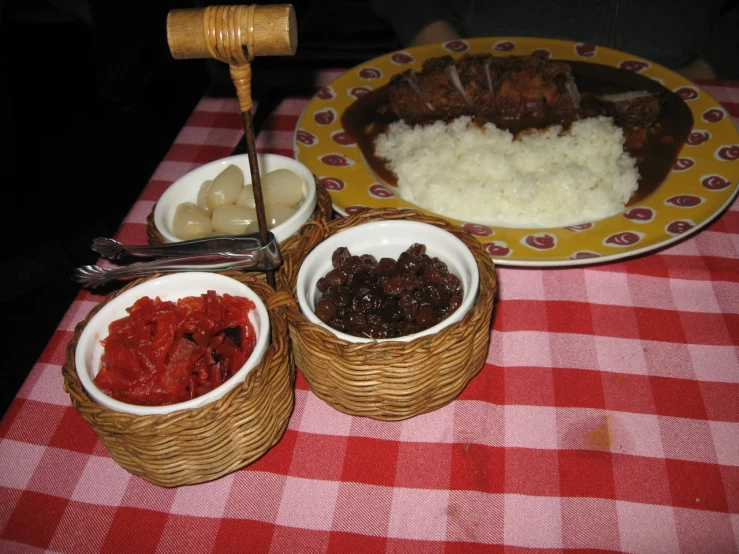three plates with meat and other food items on a table