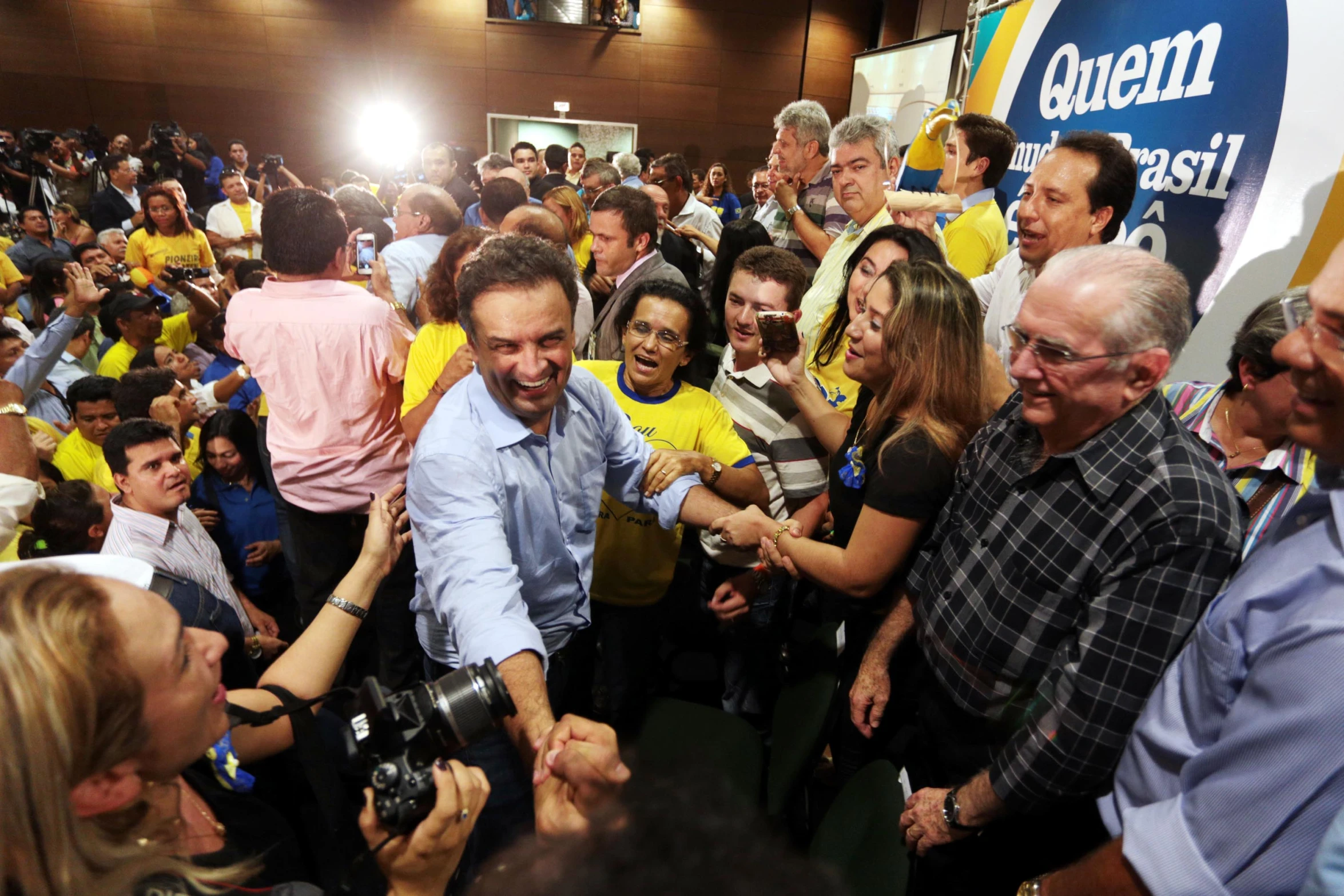 a man in a crowd shakes hands with people