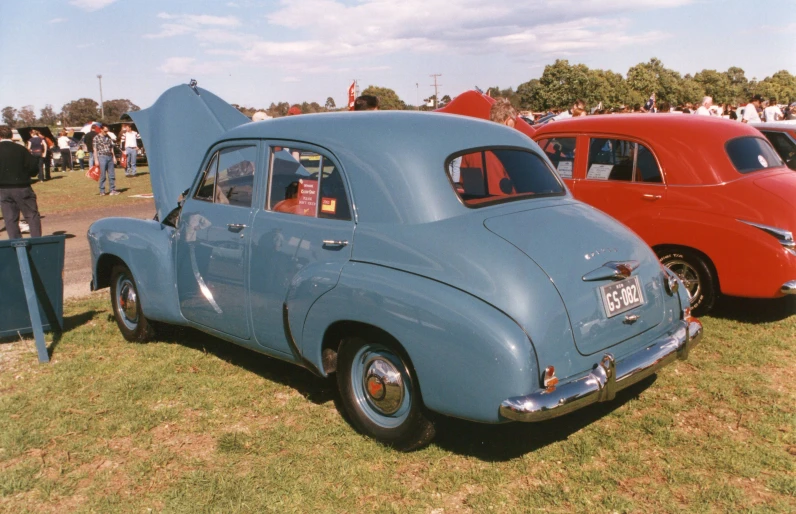 a number of old cars on a field