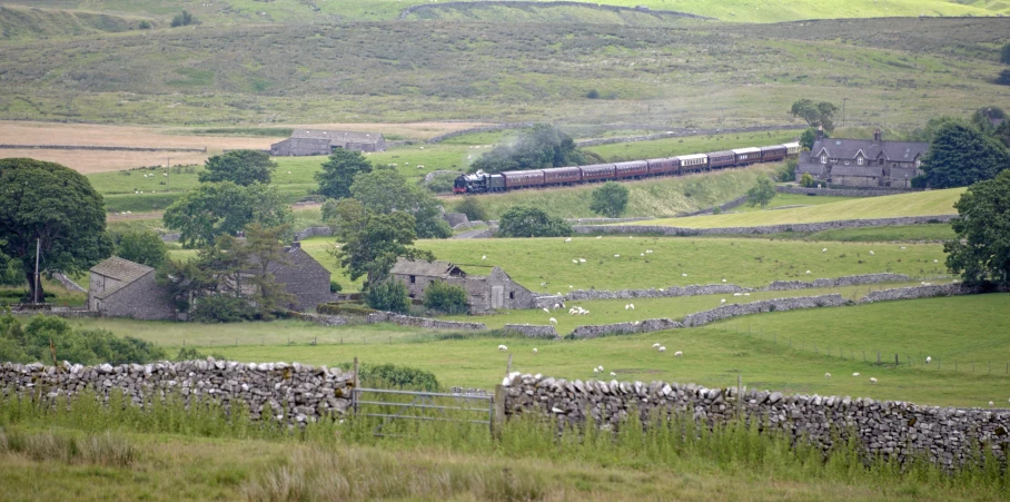 a train passes through a rural area of farmland