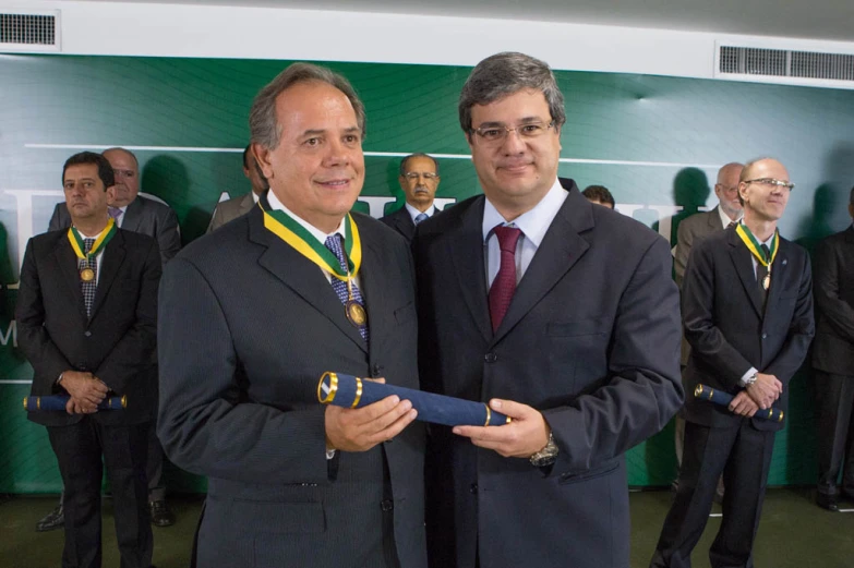 two men are posing with medals for the same organization