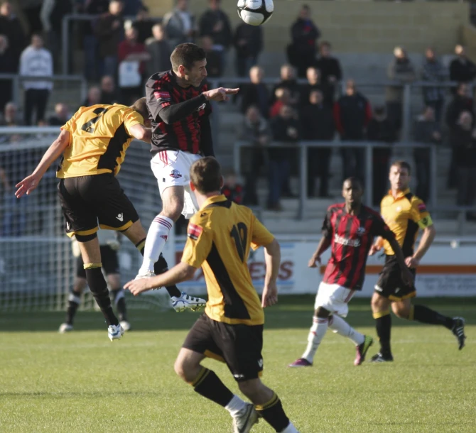 two soccer players are reaching for the ball during a game