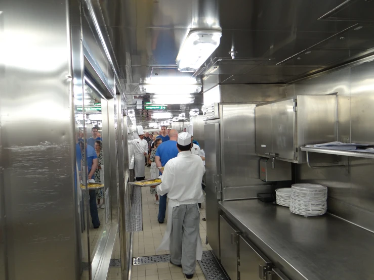 people in an industrial kitchen are cooking
