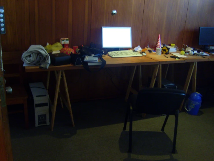 a laptop sitting on a desk with books, pictures and other toys