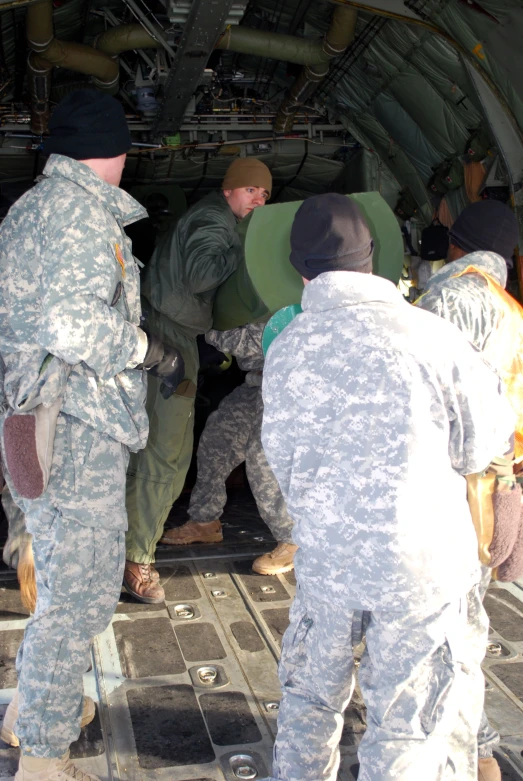 soldiers are loading and unloading their luggage in a military aircraft