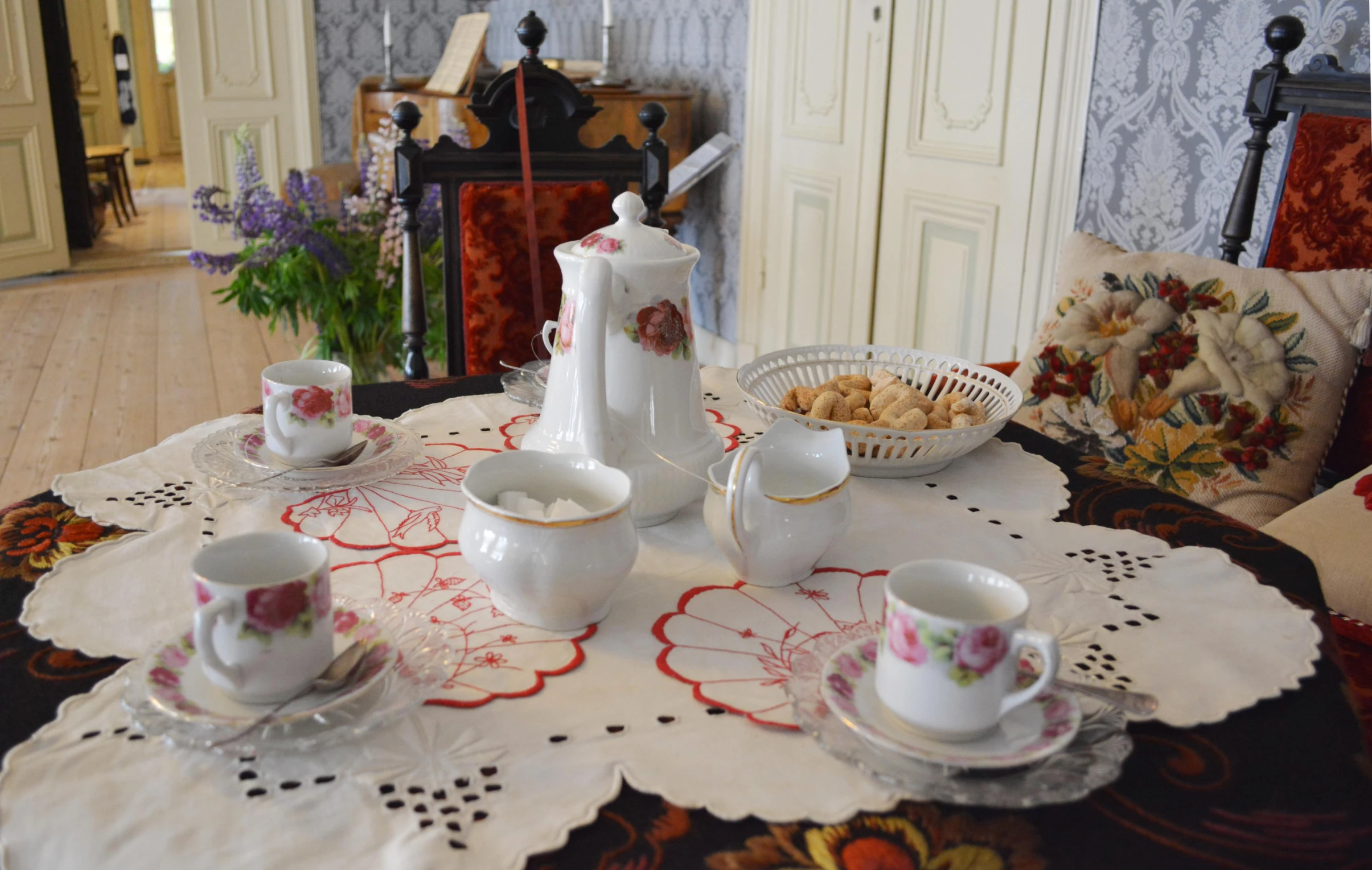 a white plate with tea cups and bowls on it