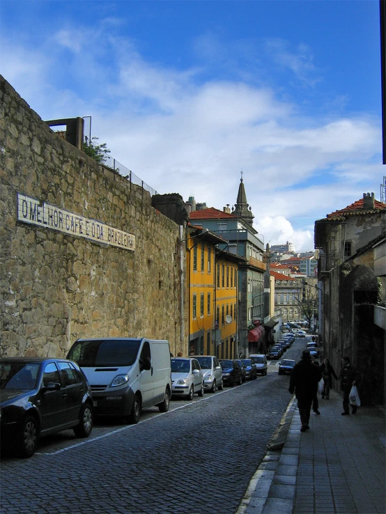 a person walking down a street next to tall buildings