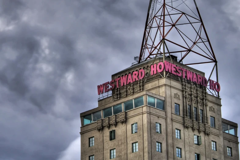 a large tower sitting next to a cloudy sky