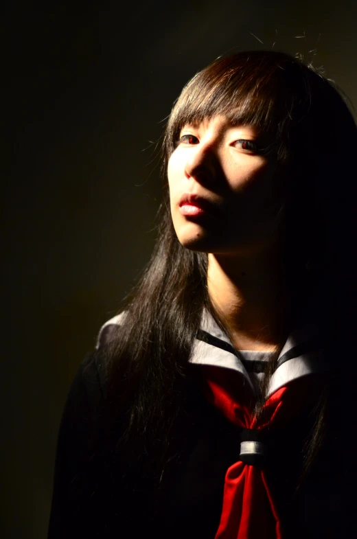 a girl in a tie looking away from the camera