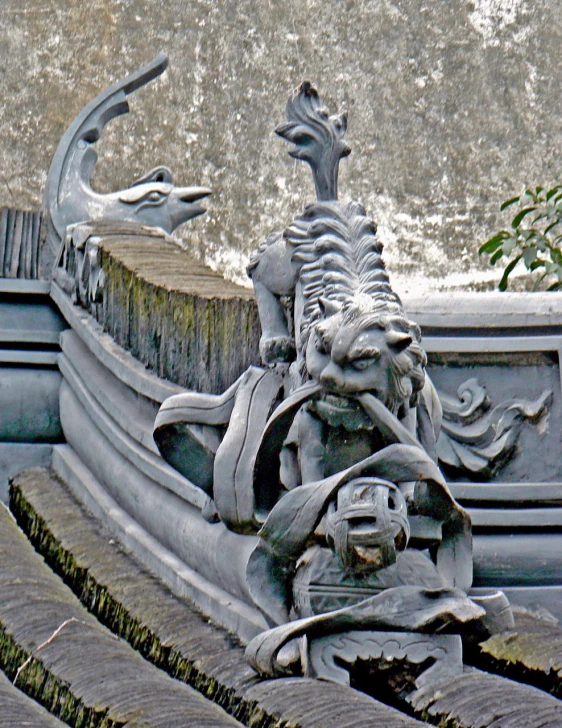 statues on top of the steps of an old building