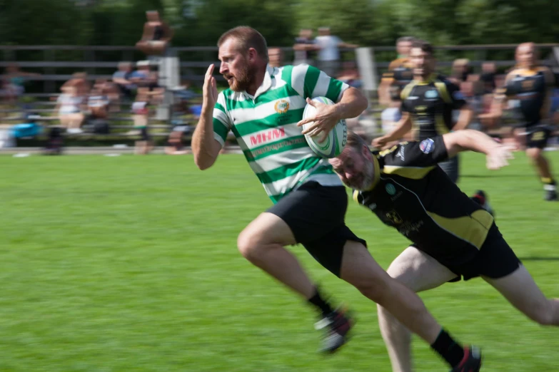 two people in striped shirts running across a field