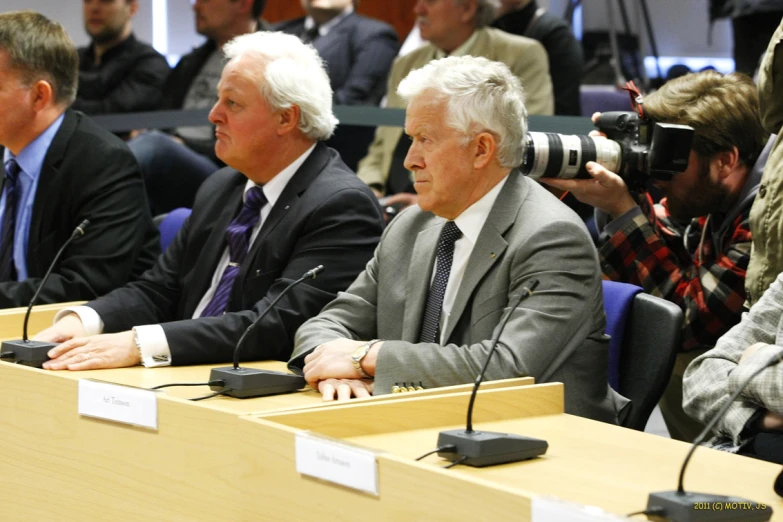 several people are sitting at the table to address