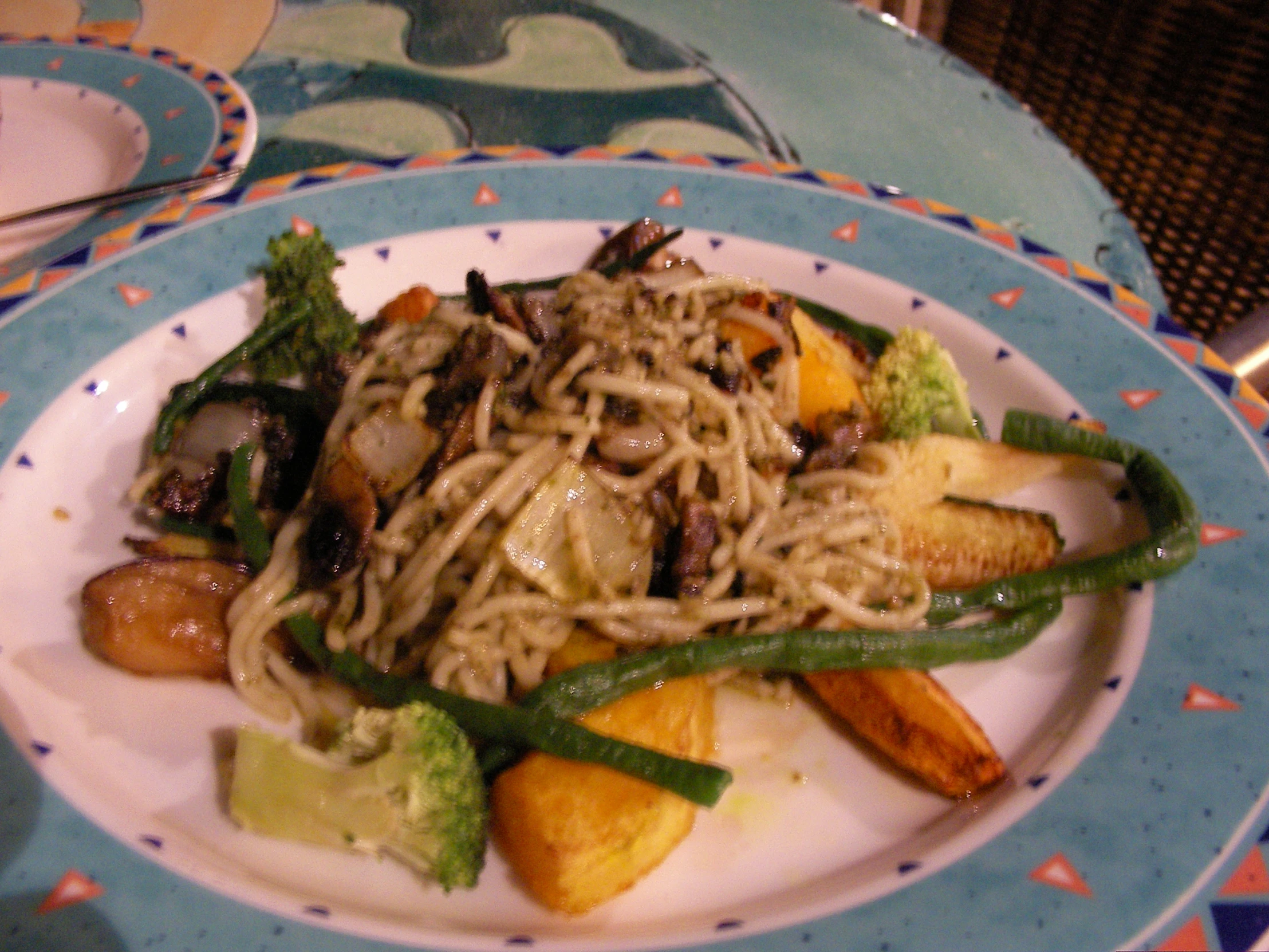 a blue and white plate with stir fry on it