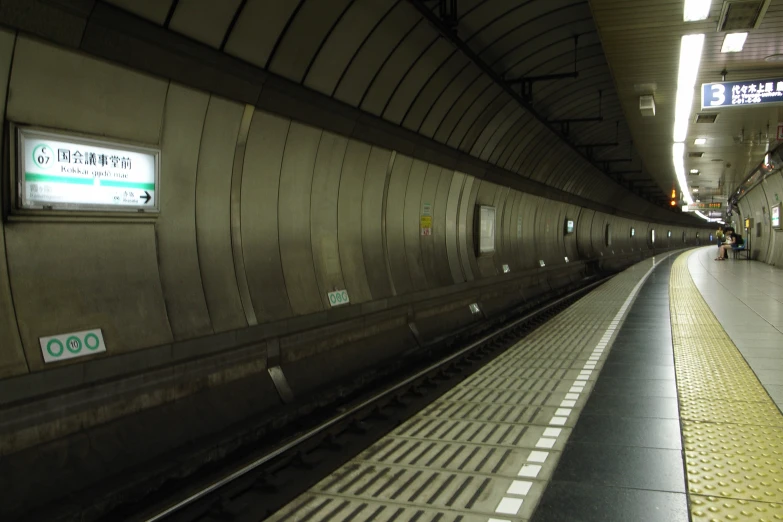 a subway platform at night with its lights on