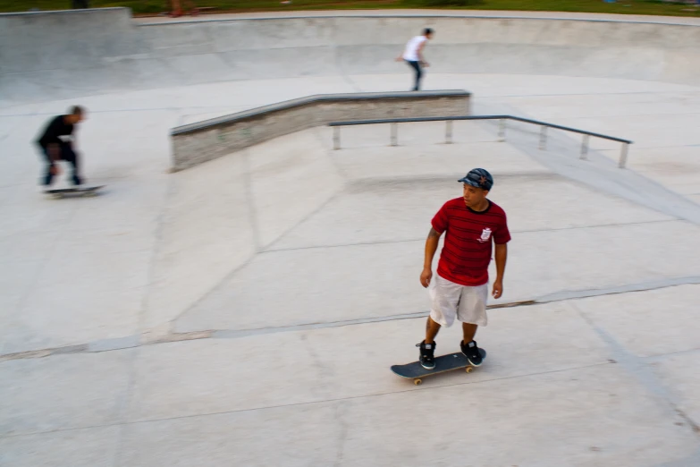 the boy skateboarding in the skateboard park is alone