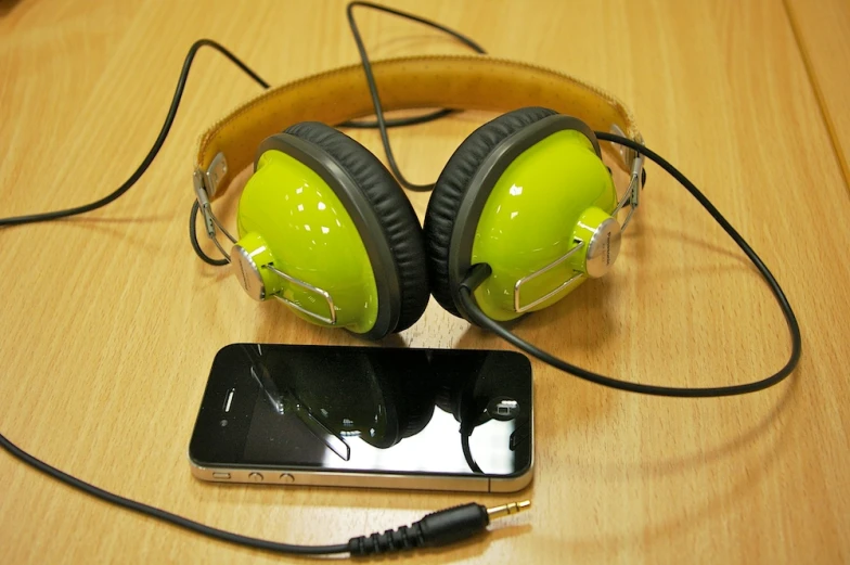 a smartphone with a pair of headphones attached