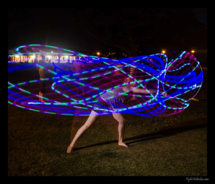 the woman is throwing a big object with lights on her