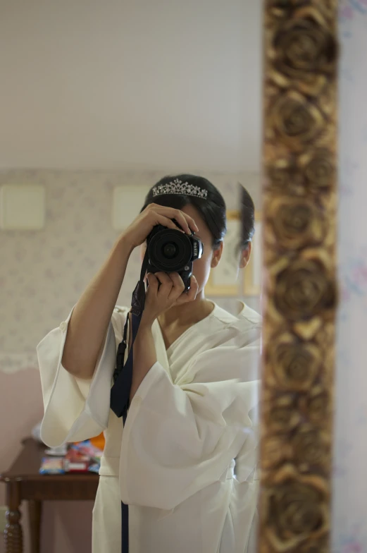 a woman in a kimono taking a po of herself