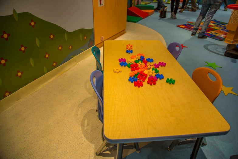 the tables with different colored puzzle pieces are on display
