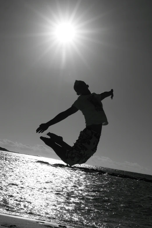 the man is doing a trick on his surfboard