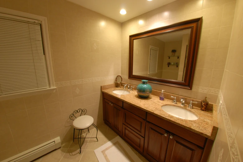 a light filled bathroom with a mirror above the double sinks