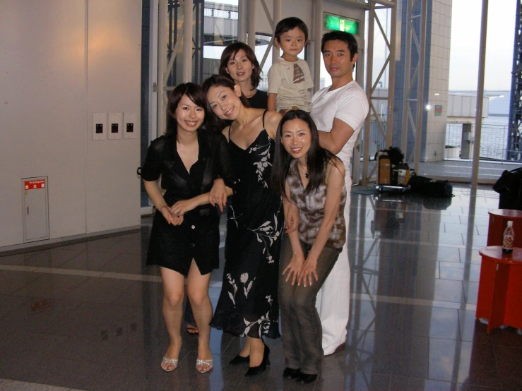 a group of people standing together posing for a po
