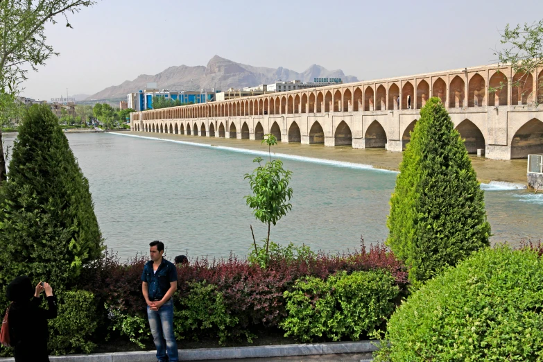 two people on a pathway near the water