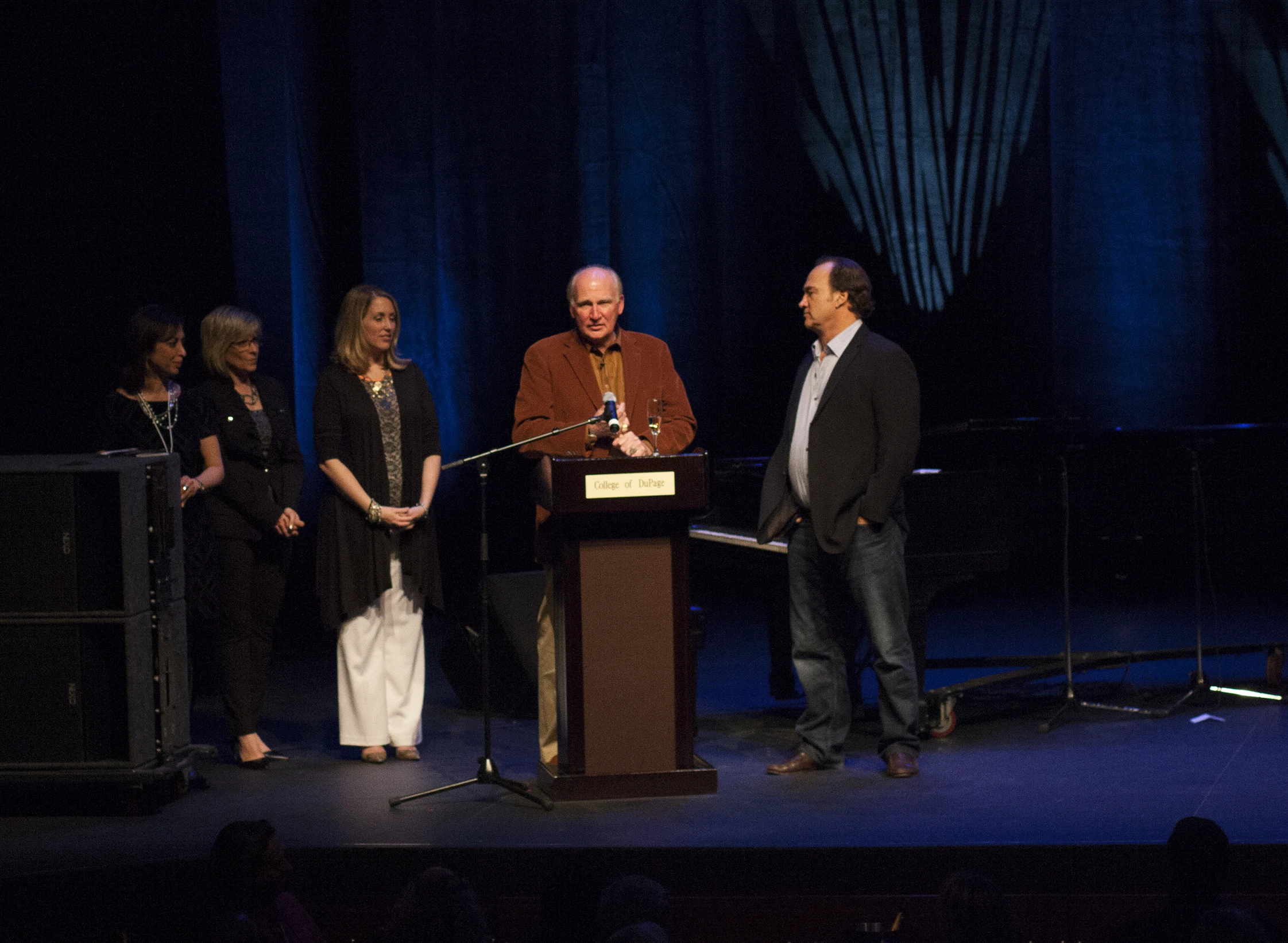 some people are at a podium for an awards ceremony