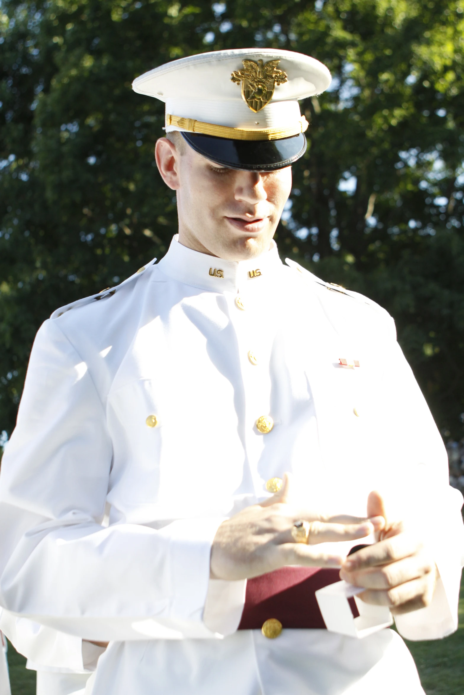 a naval officer in uniform poses for a pograph