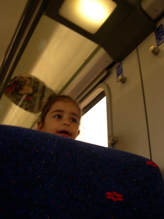 a  looking through the window on a bus