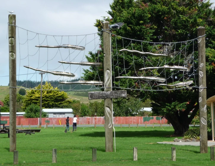 there are several poles that have been set up to hold a large piece of artwork