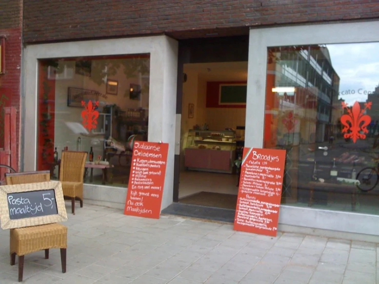 a row of chairs outside of a shop with an awning