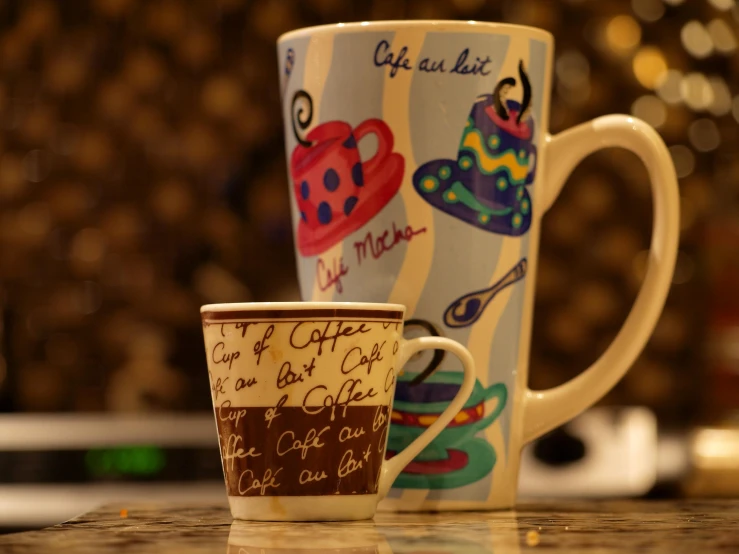 two coffee cups sitting side by side on a counter