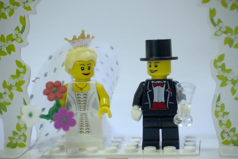 a toy man and woman are holding hands