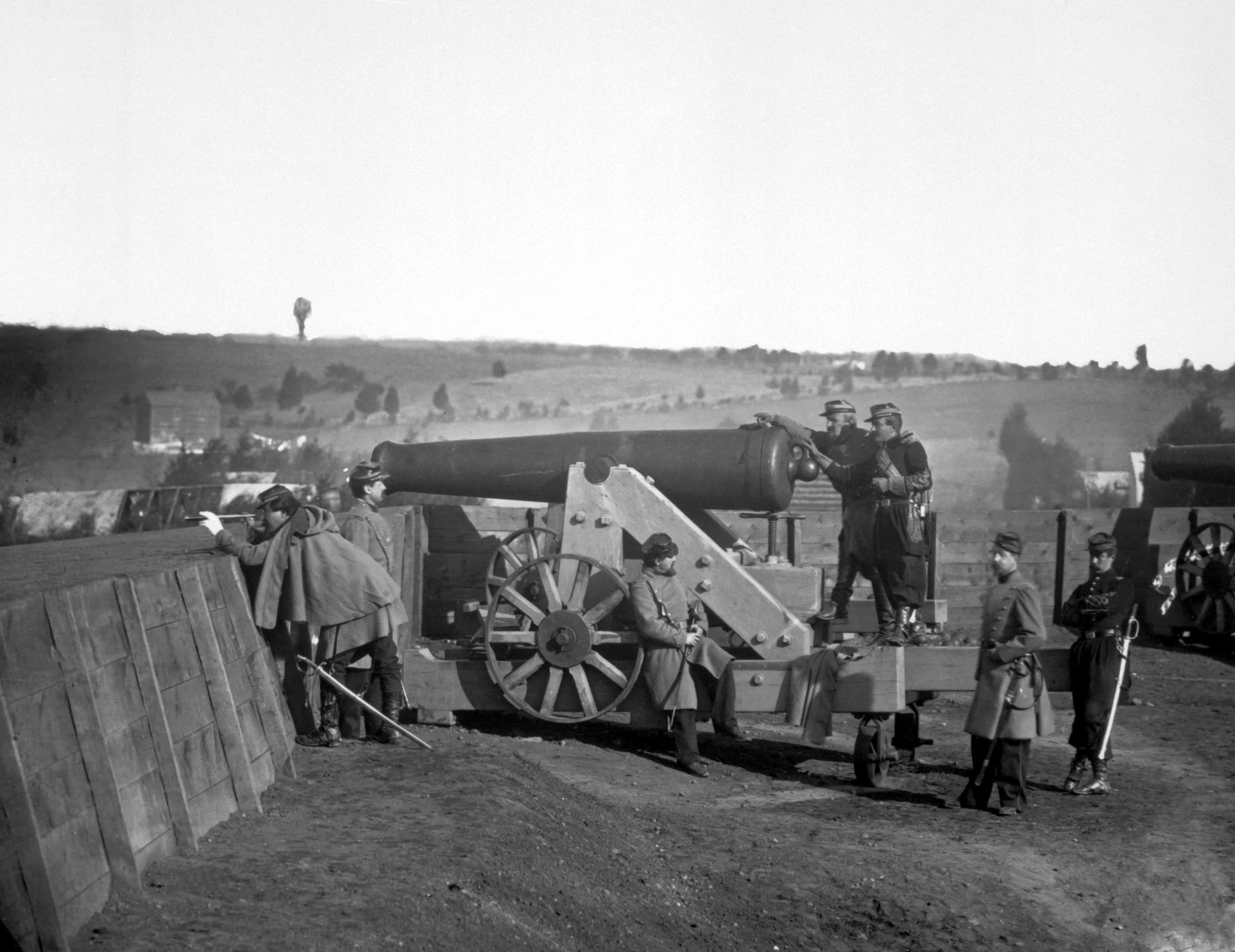 the men stand next to two large cannones