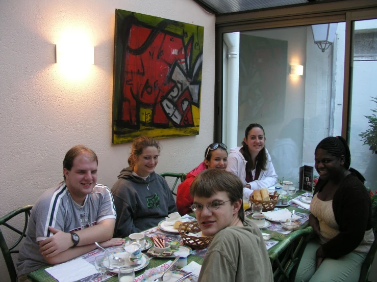a group of people sitting at a table smiling