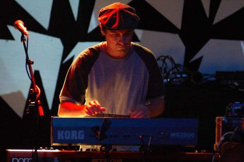 a man standing in front of a keyboard and a microphone