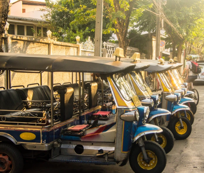 a row of small electric vehicles parked on the street