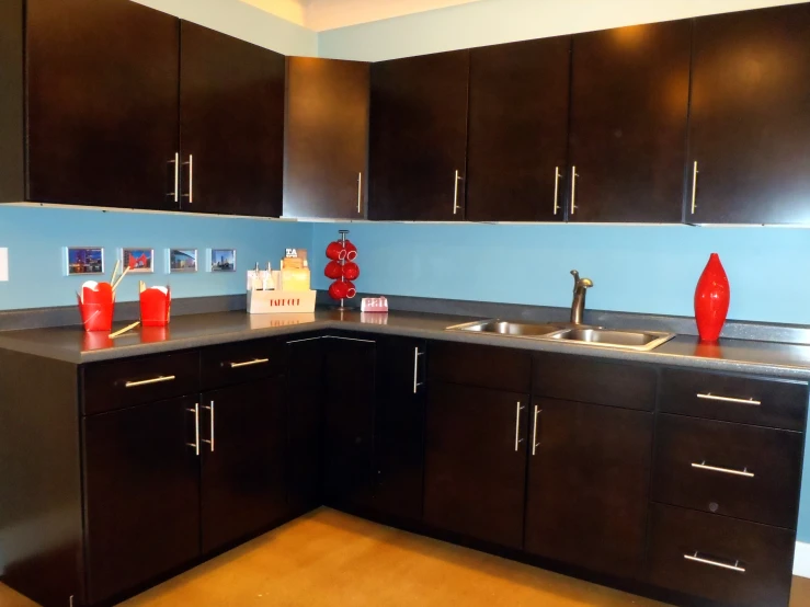 a kitchen with cabinets and black counter tops