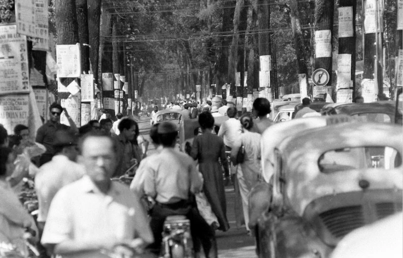 black and white pograph of people walking on the street