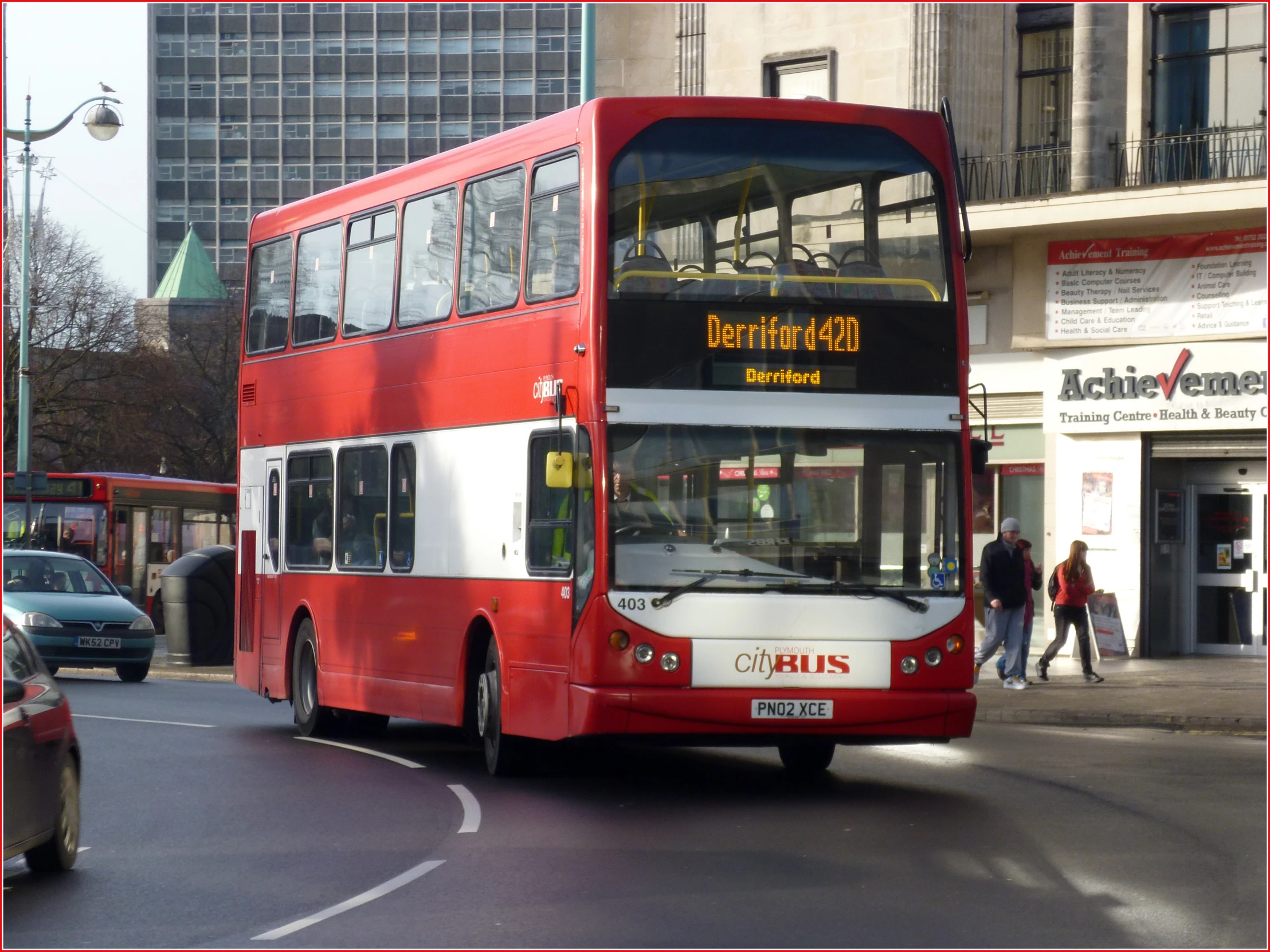 a double - decker bus driving down the street