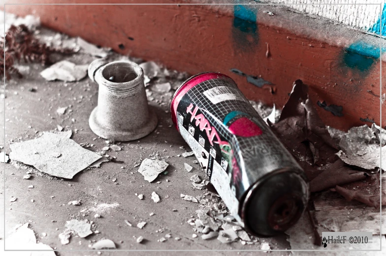 a pair of tennis shoes are laying next to an old bottle