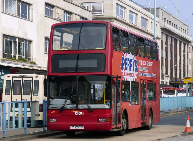 a double - decker bus parked at the curb of a city street