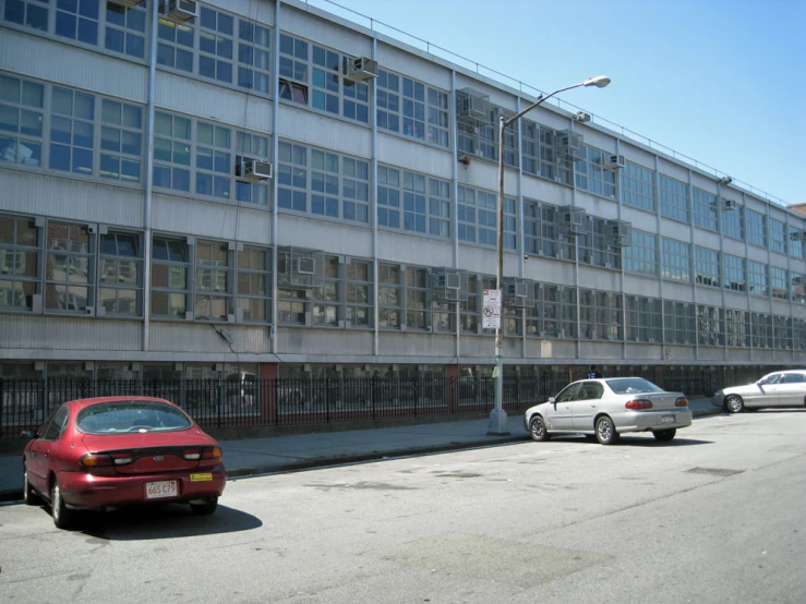 there are cars that are parked in front of this building