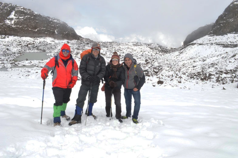 a group of four people are in the snow